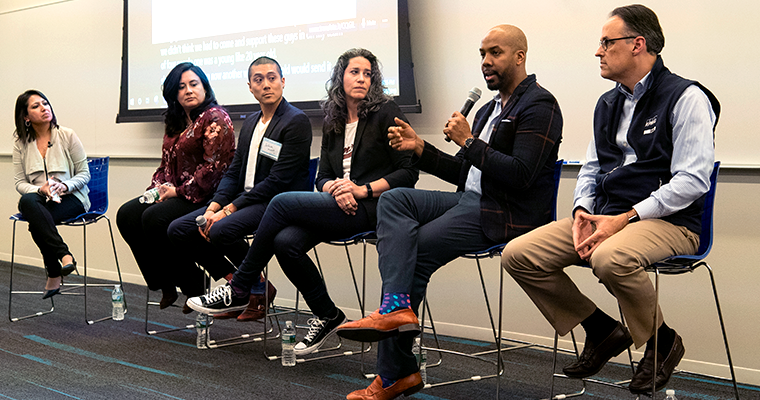 panel of speakers on stools