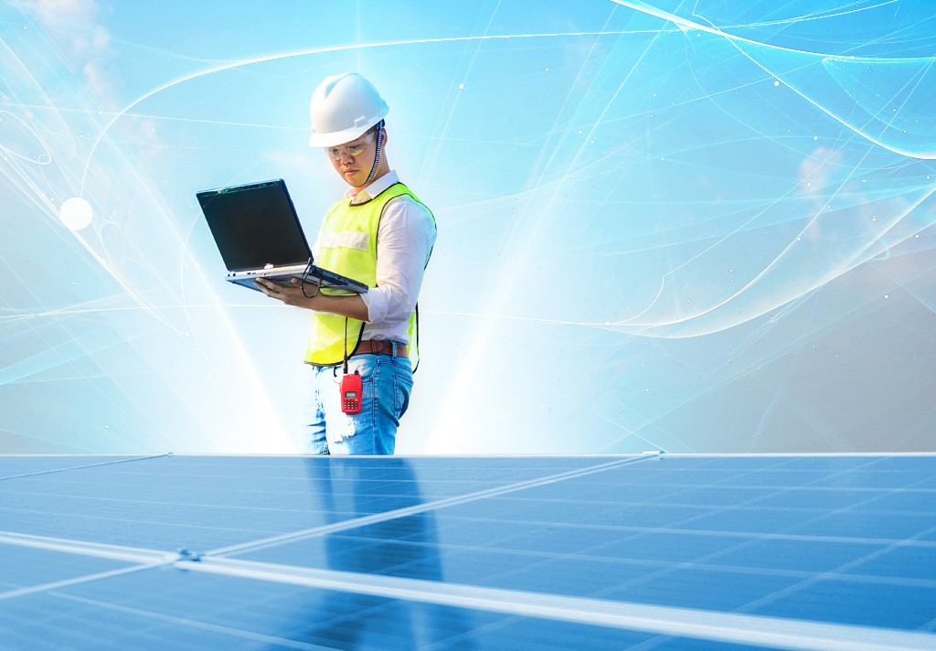 construction worker looking down at his laptop