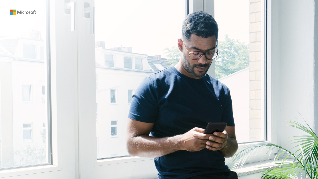 man looking down at his phone