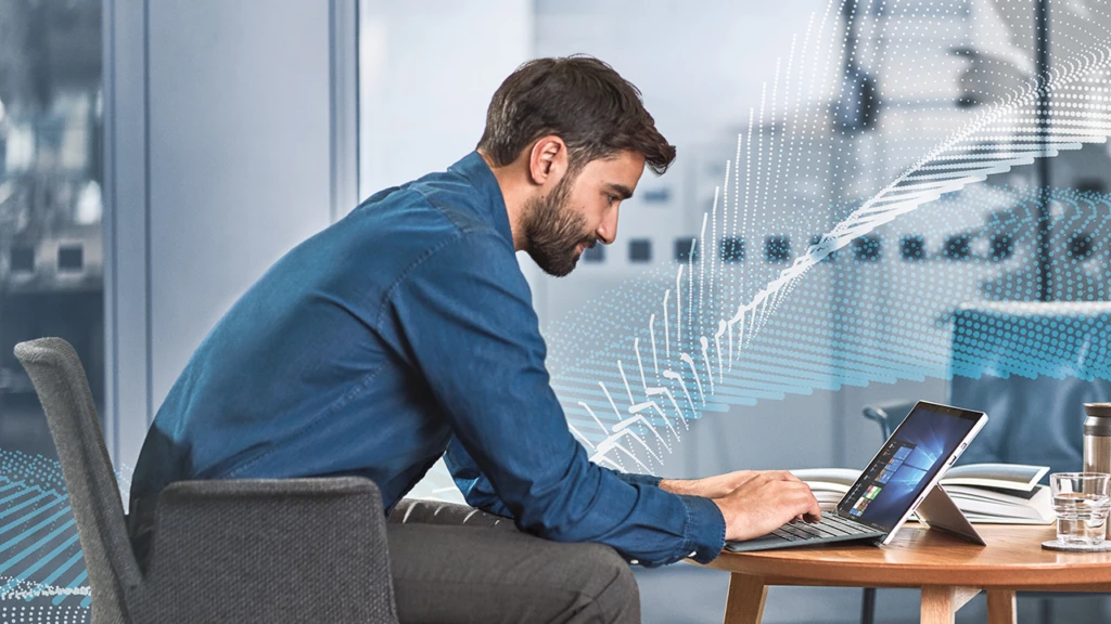 man sitting on the couch working on his tablet