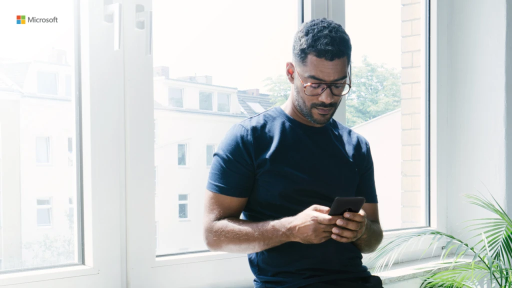 man looking down at his phone