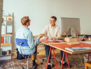 Two men sitting at a table and talking