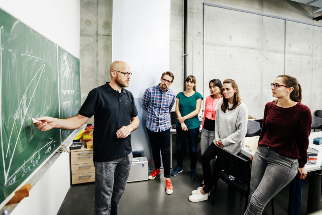 A group of people standing in a classroom
