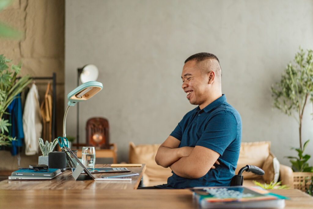 A man sitting at a desk with his arms crossed