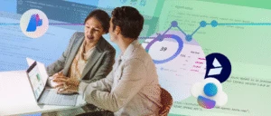 Two colleagues collaborating and working together on laptops. The background features graphs and charts