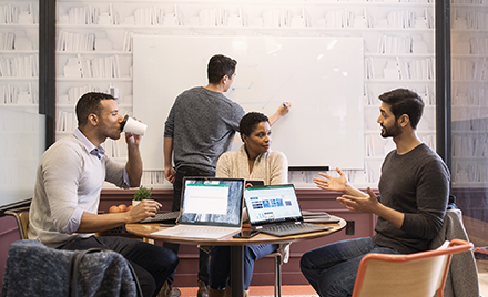 Image of a small worker gathering in a conference room.