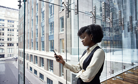 Image of a worker checking her phone.
