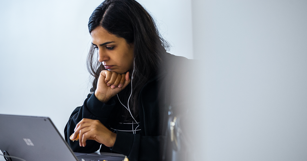 Image of a developer working remotely on her laptop.
