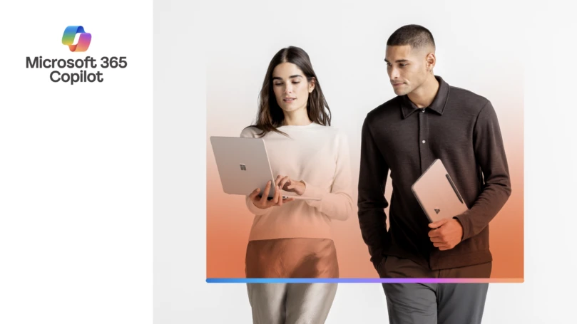 A man and woman holding laptops with text that reads "Microsoft 365 Copilot"