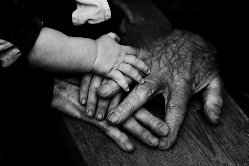 Three people holding hands together