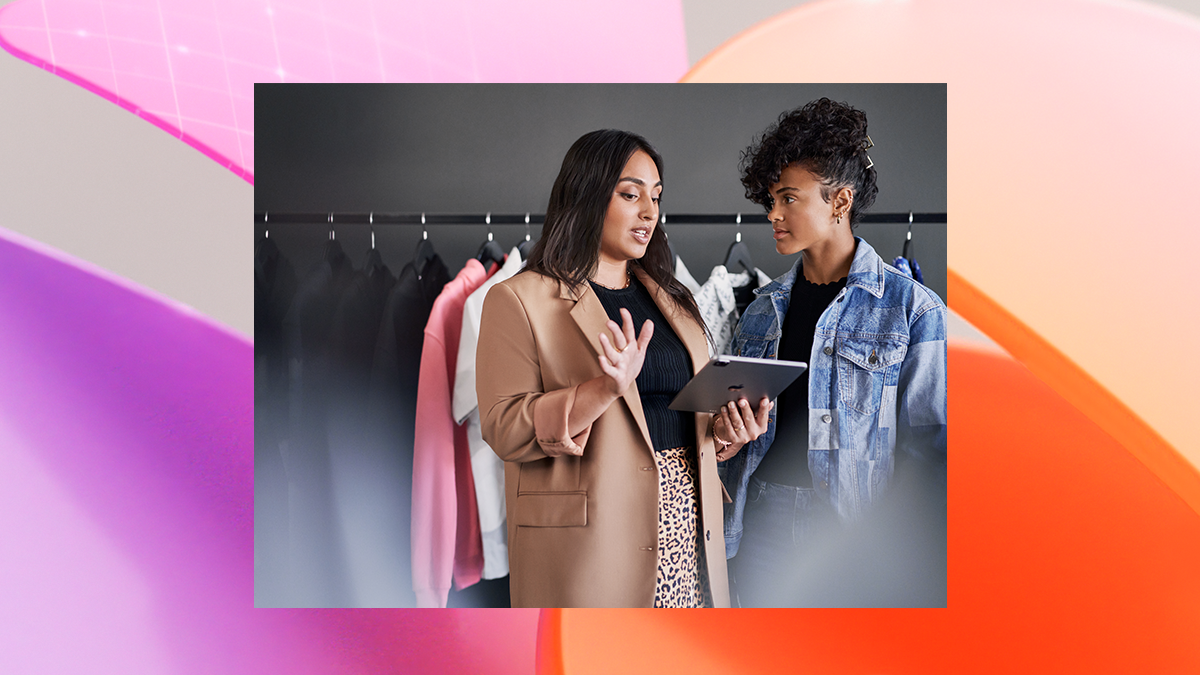 Empowered retail business manager reviewing real time data with employee.