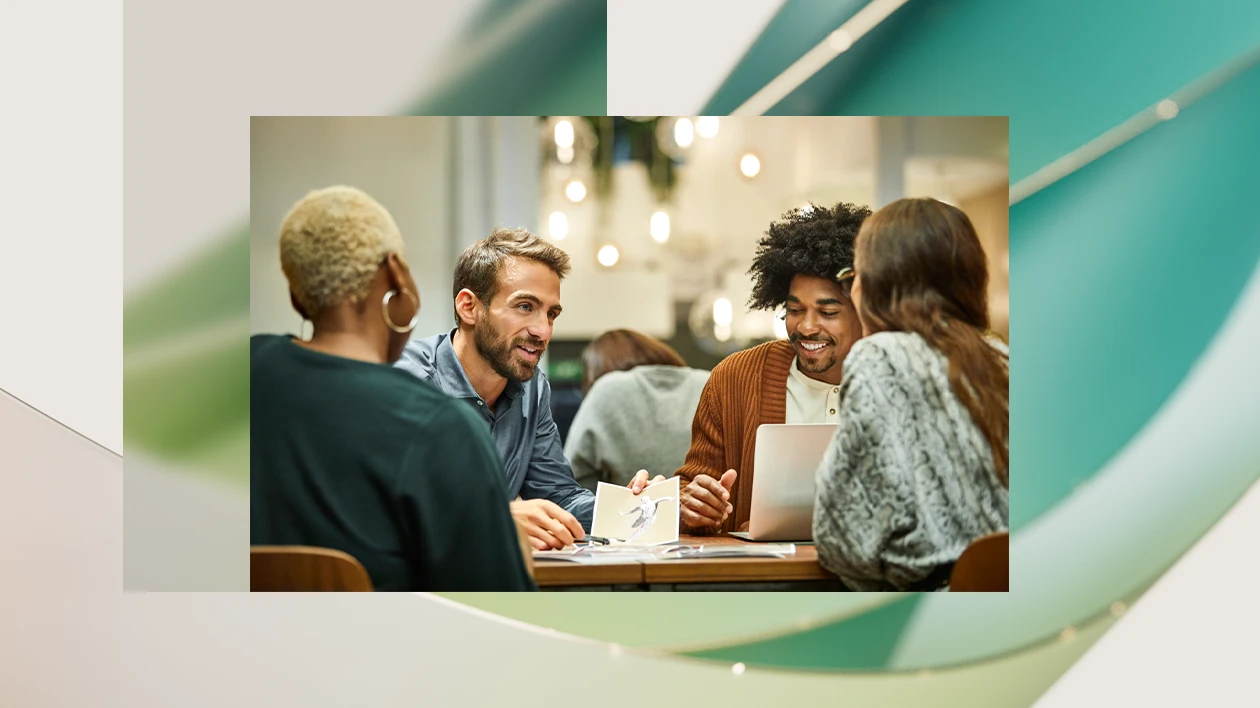 A group of people having a discussion around a table.