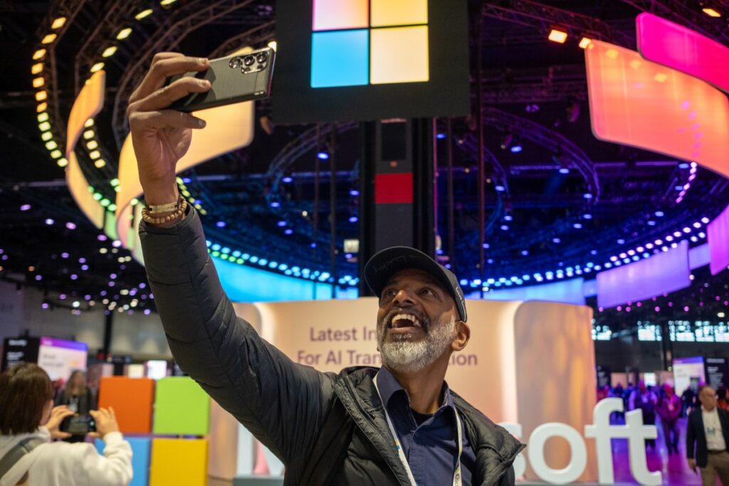 A man taking a selfie at a Microsoft security event.