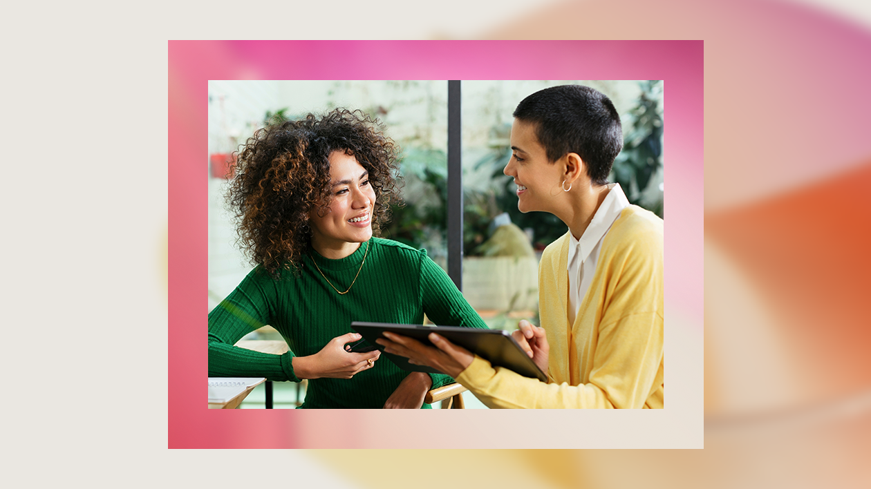 A woman holding a tablet and smiling
