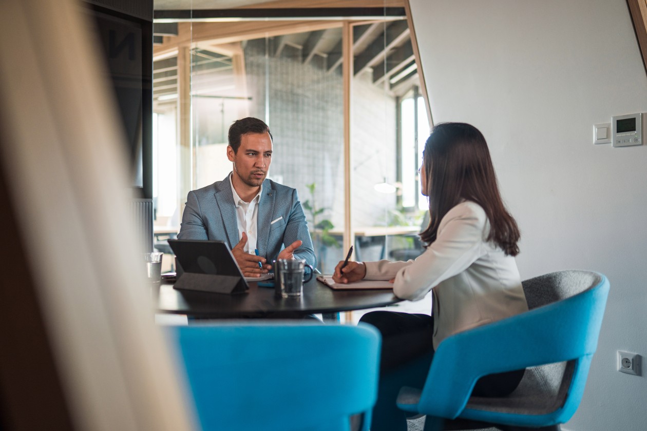 Coworkers brainstorm ideas in a modern office space.