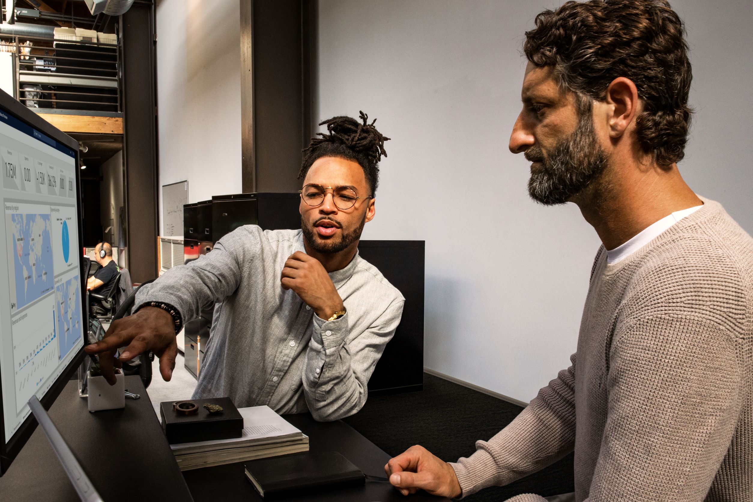 Man points to analytics on the screen showing colleague findings