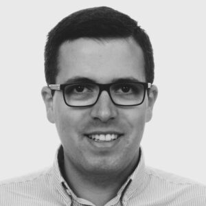 A man wearing glasses and smiling