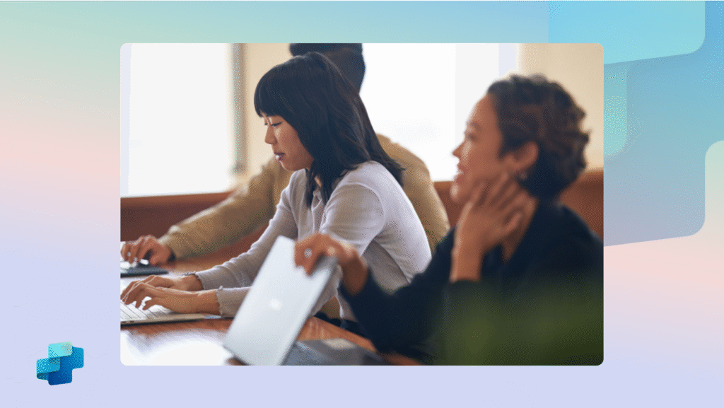 Three people collaborating on laptops