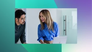 A man and woman looking at a laptop