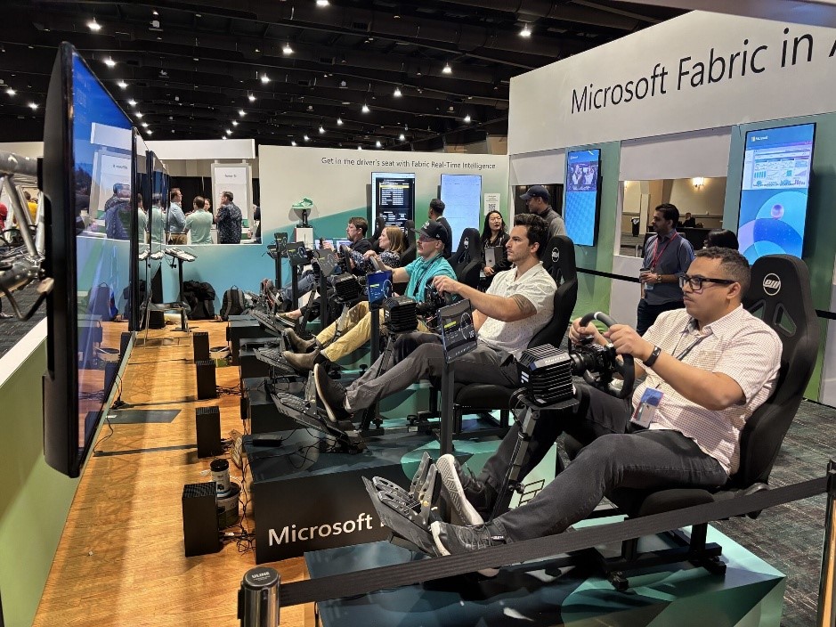 A group of people sitting in chairs in a room with screens