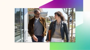 Two people walking and talking outside.