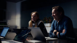 Thumbnail image - A man and woman sitting at a table with laptops.