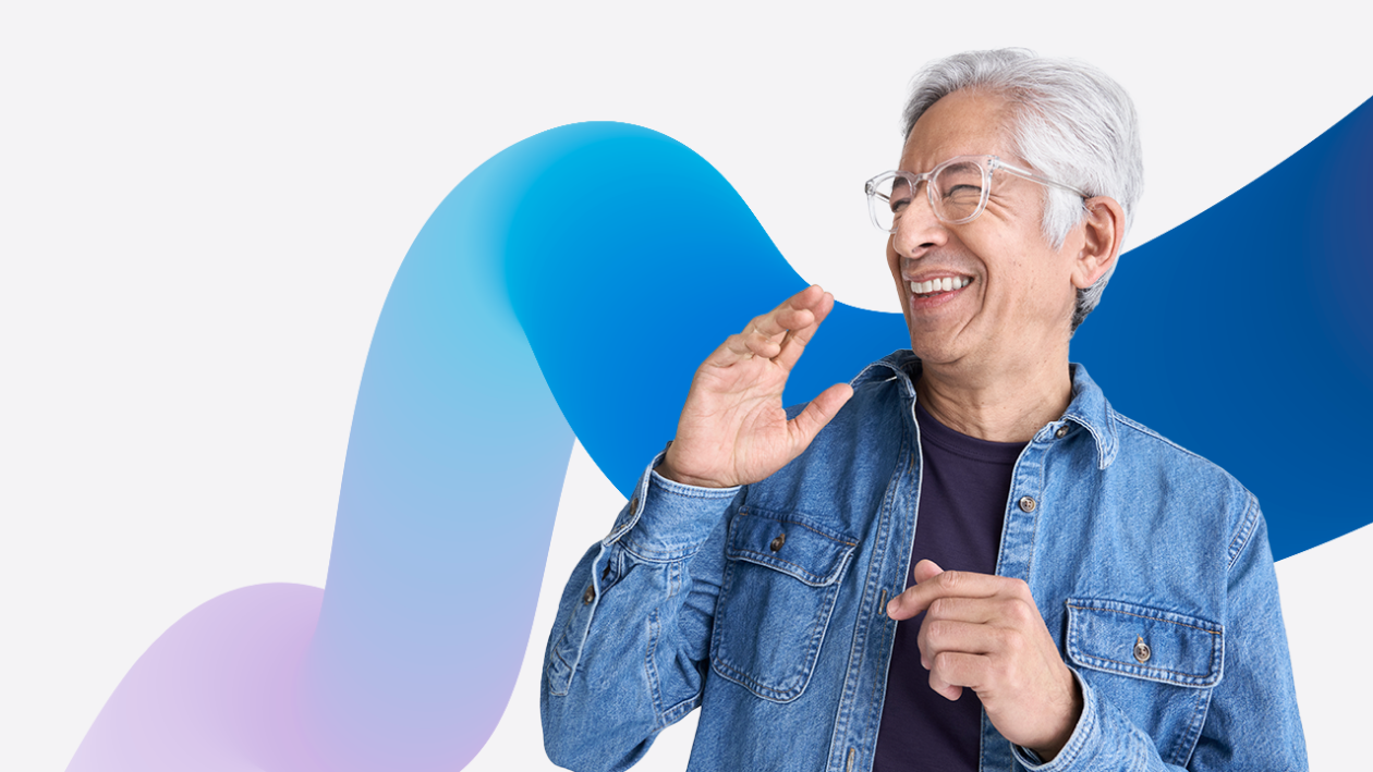 A person in a denim jacket and glasses looking to the side laughing. The image is overlaid on a purple and blue gradient squiggle graphic.