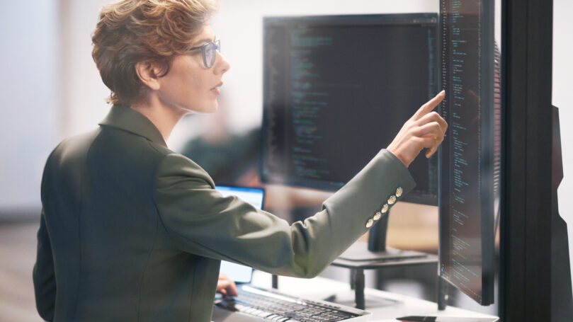 A woman pointing at a computer screen