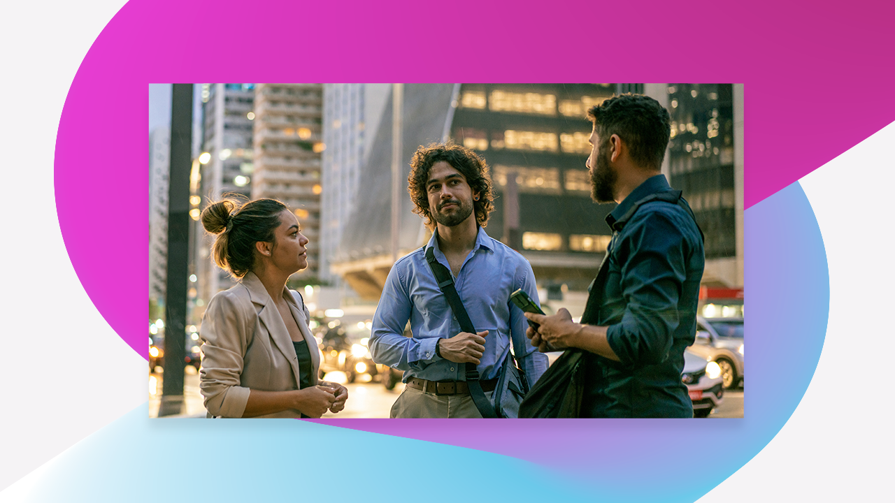 three people having a conversation on the street