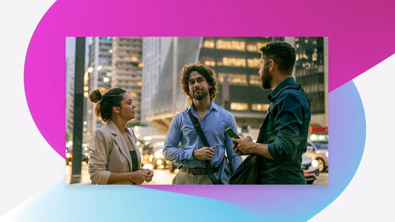 three people having a conversation on the street
