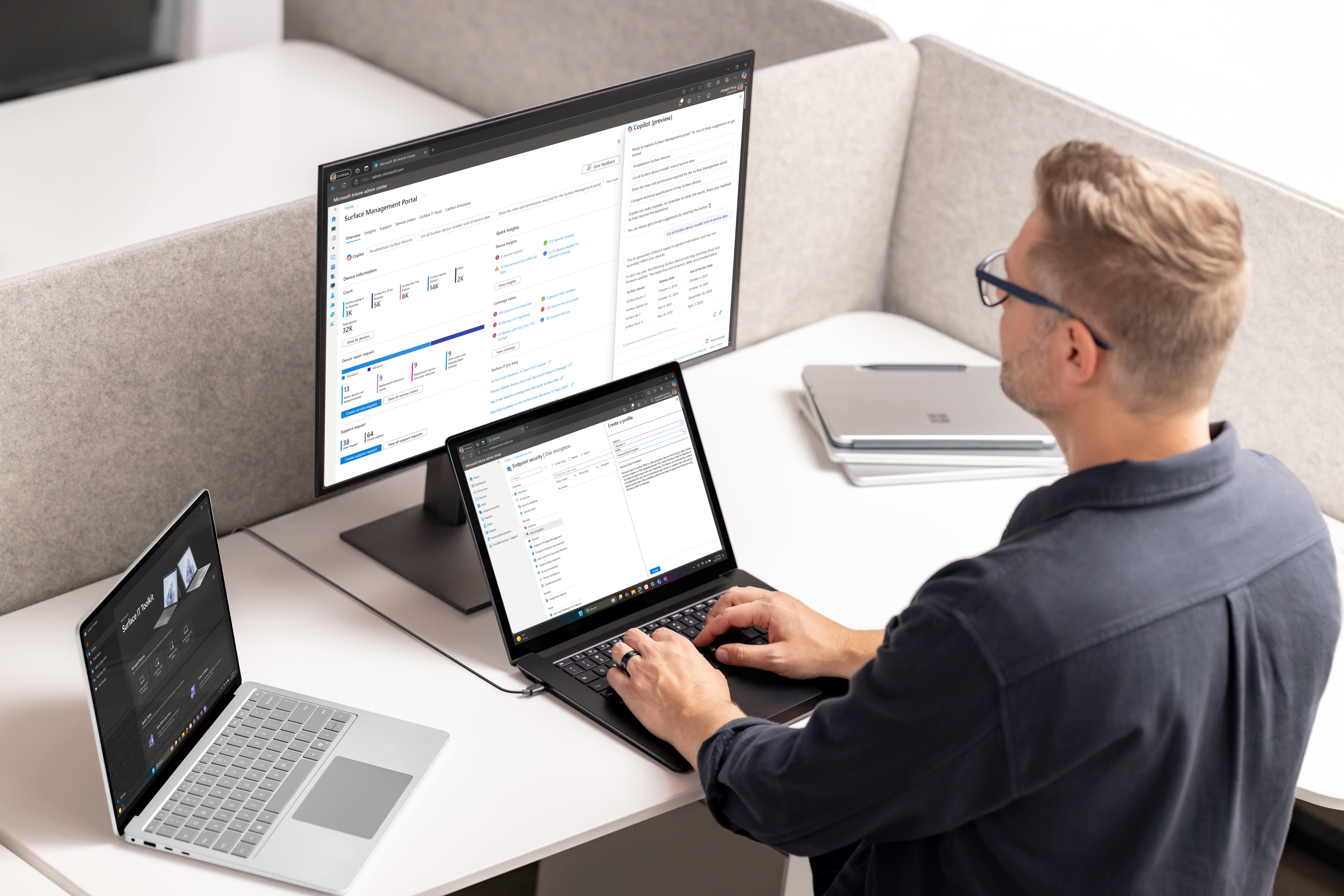 A man sitting at a desk with two computers