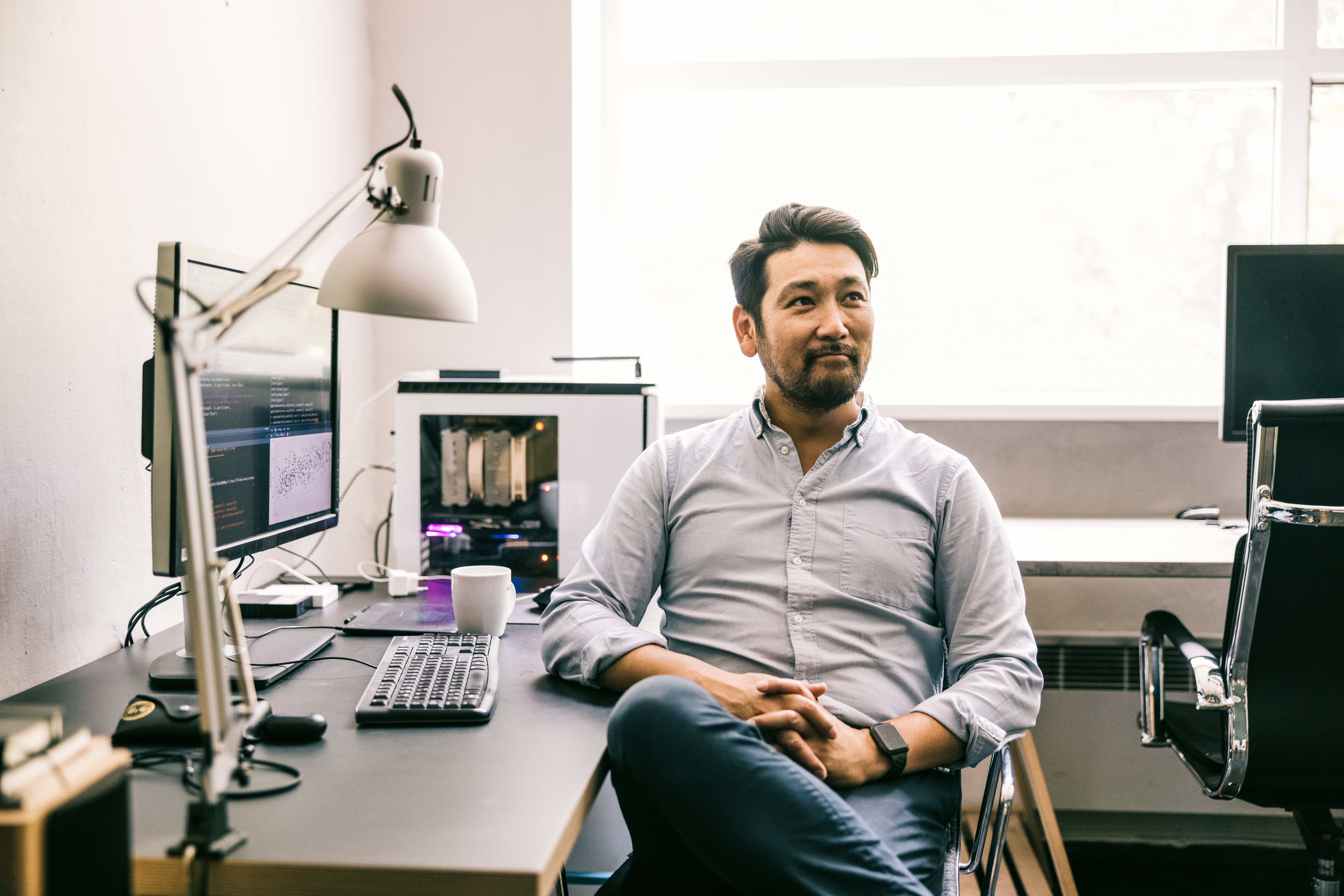 A man sitting at a desk with a computer