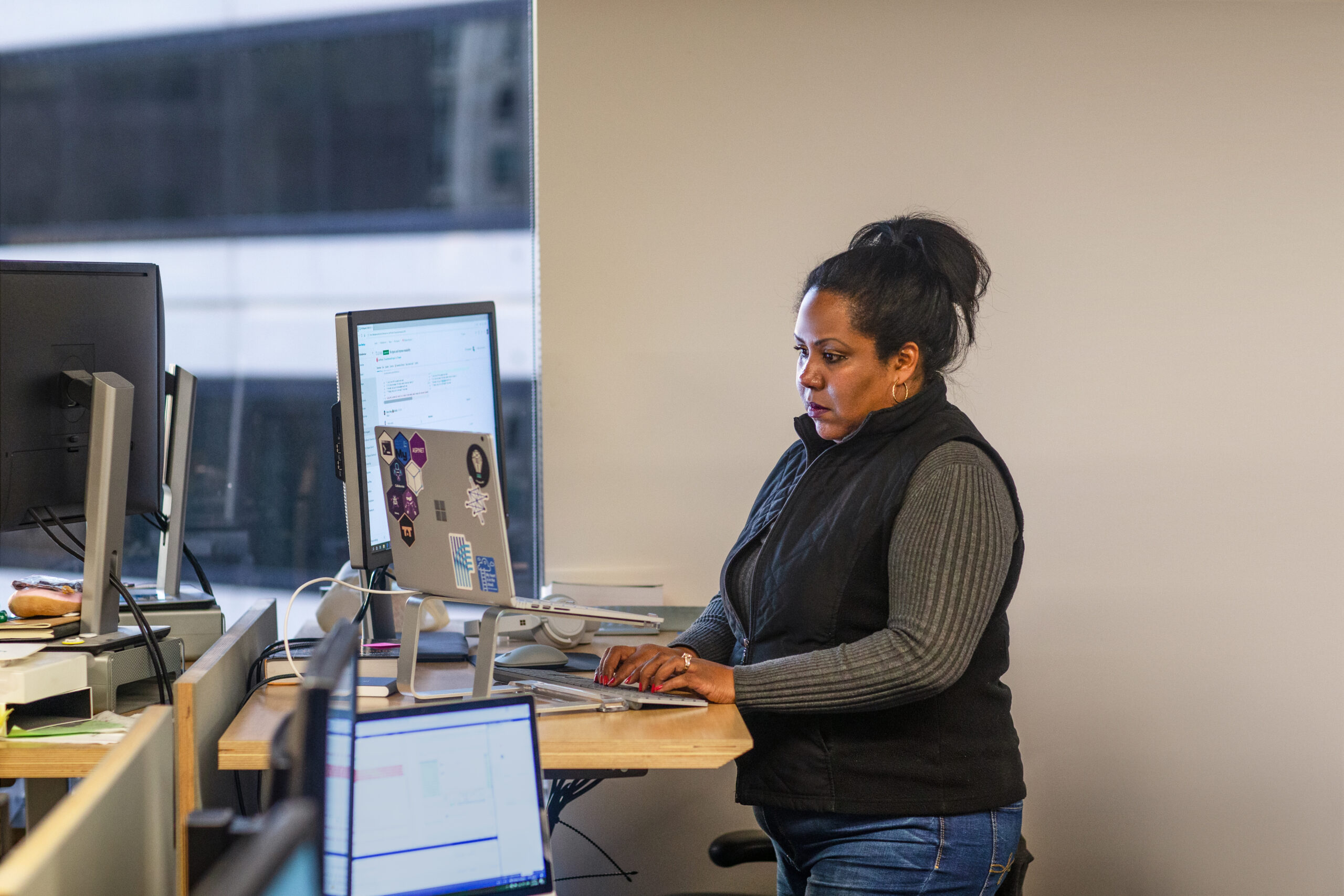 A woman standing in front of a computer