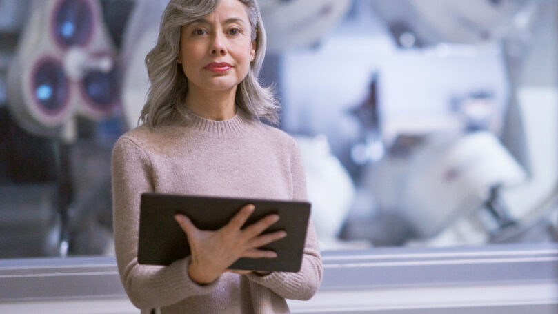 A woman holding a tablet