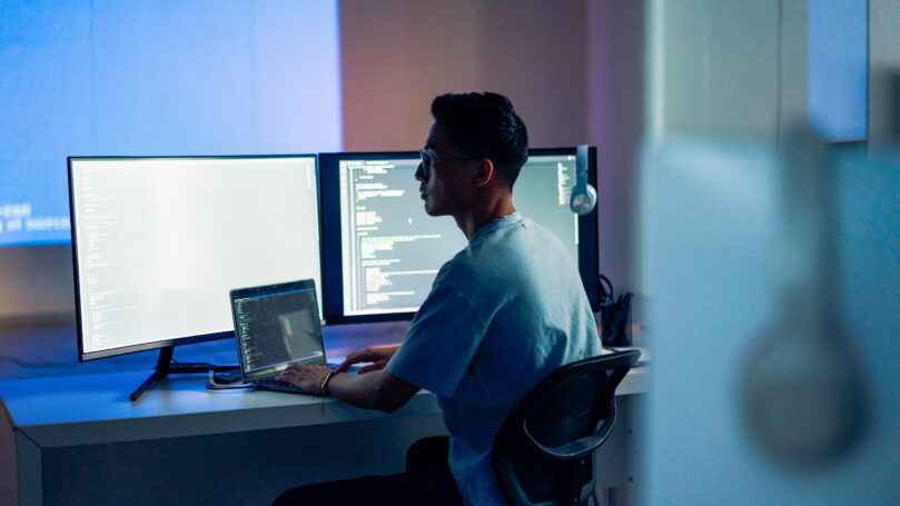 A man sitting at a desk with a computer