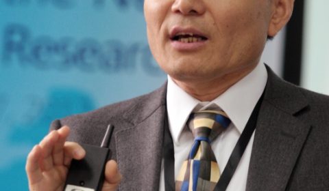 a man wearing a suit and tie talking on a cell phone