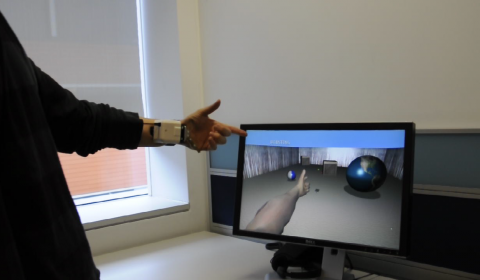 a man standing in front of a monitor