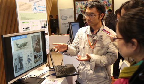 a group of people looking at a laptop