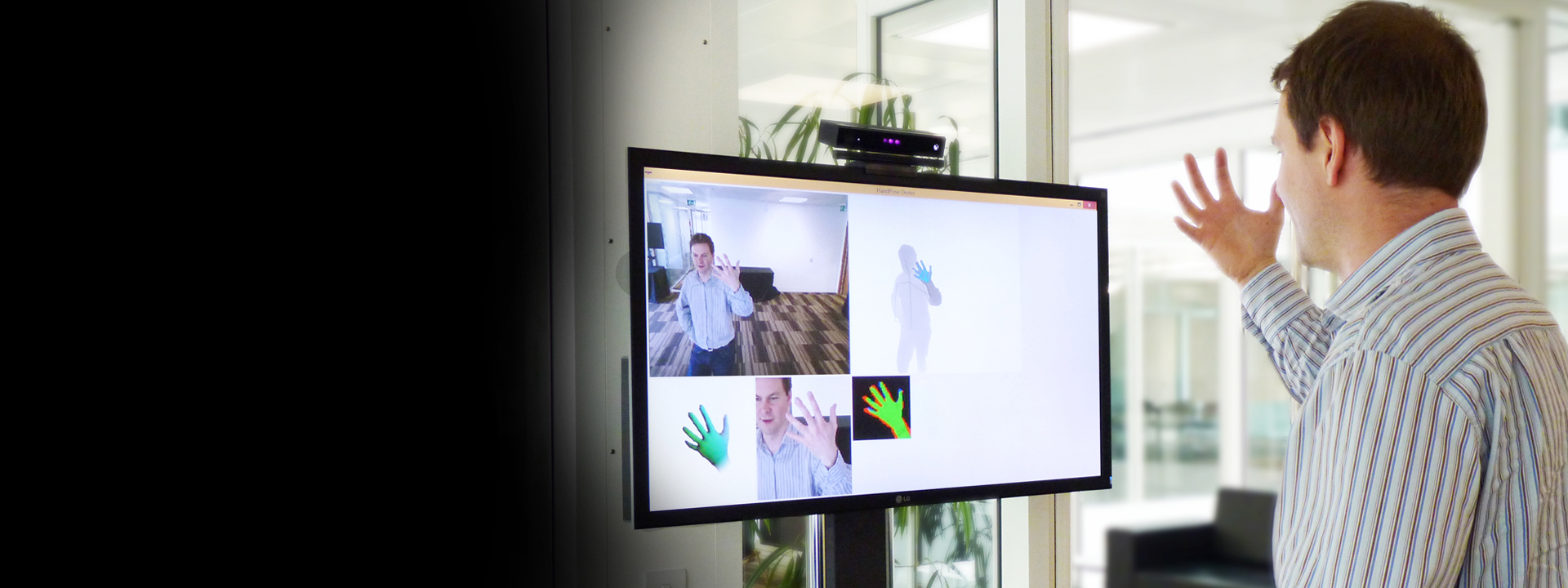 a person standing in front of a flat screen television