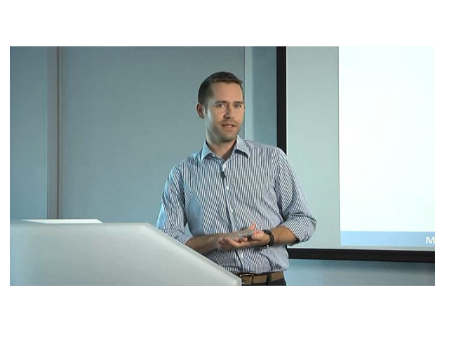 Mike Ananny sitting in front of a laptop