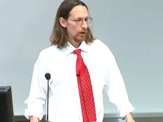 Rob Walker wearing a suit and tie