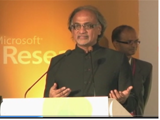 P. Anandan wearing a suit and tie