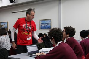 a group of people standing in front of a computer