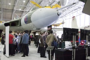 a group of people standing around a plane