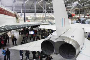 a group of people standing around a plane