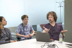 Simon Farnaby et al. looking at a laptop
