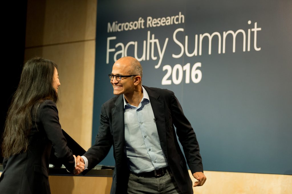 Jeannette M. Wing & Satya Nadella shake hands before fireside chat