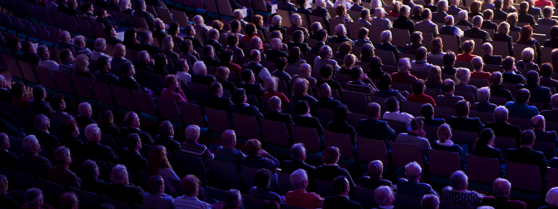 a large crowd of people in a dark room