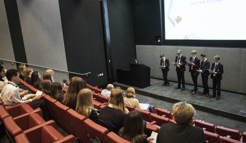 a group of people sitting in front of a crowd