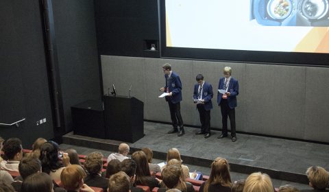 a group of people standing in front of a crowd